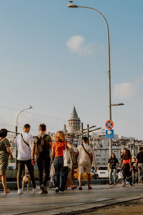 Free People walking near Galata Tower in Istanbul, capturing vibrant urban life with iconic architecture. Stock Photo