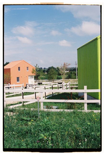 Capture of vibrant barns surrounded by fences and greenery in Dvoryaninovo, Tula Oblast, Russia.