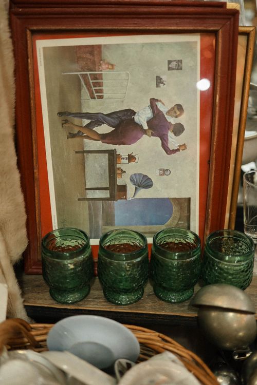 Free A vintage collection featuring a framed artwork and textured green glasses. Stock Photo