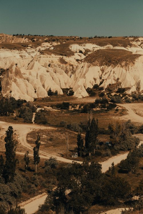 Free Explore the eroded rock formations and unique landscape of Cappadocia in this aerial view. Stock Photo