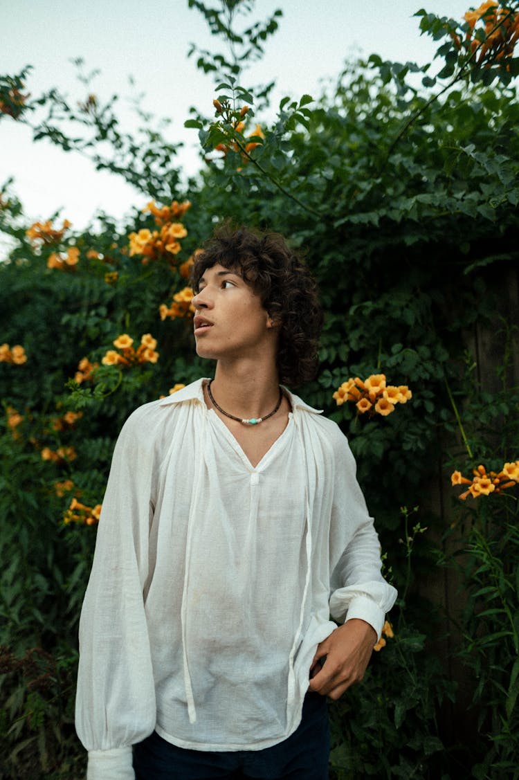 Man Posing In Garden With Flowers