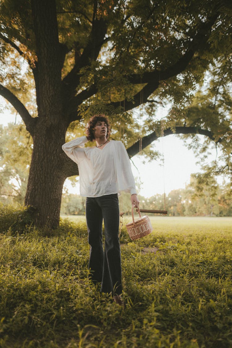 Hippie Man With Basket Standing Under Tree