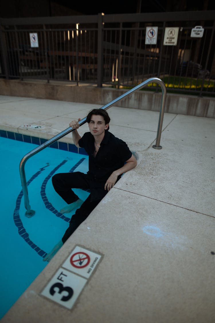 Man Sitting On A Pool 