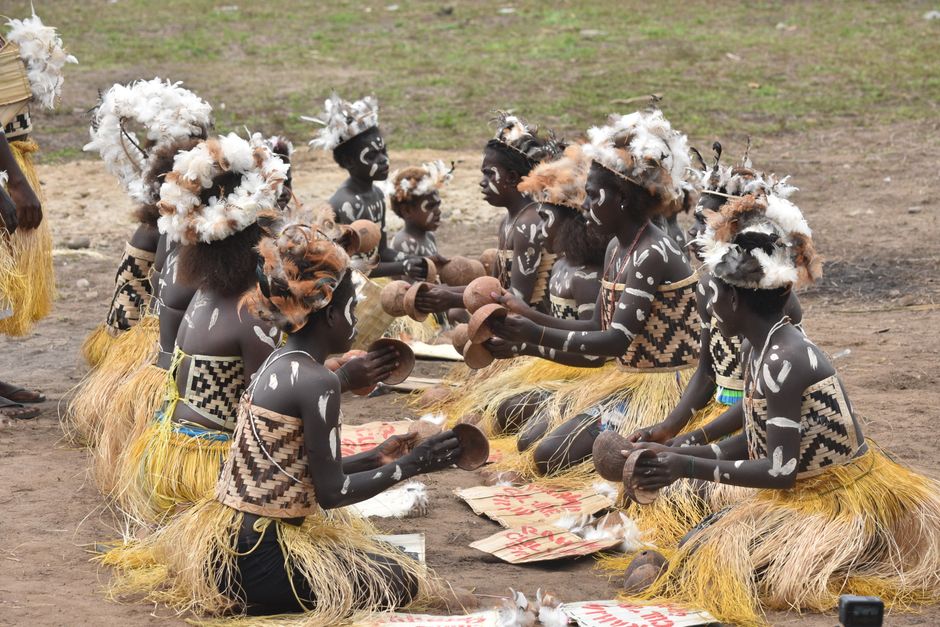 Indigenous people in traditional clothing and cultural artifacts in central Brazil