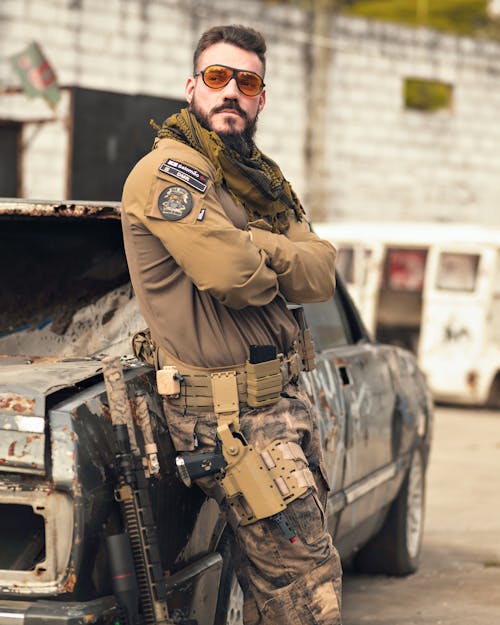 Soldier in a Uniform Leaning Against a Car 