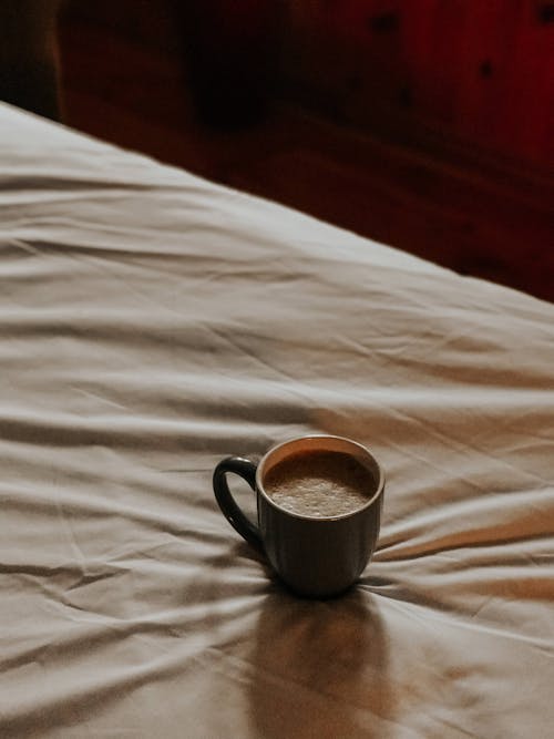A Coffee Cup on a Bed