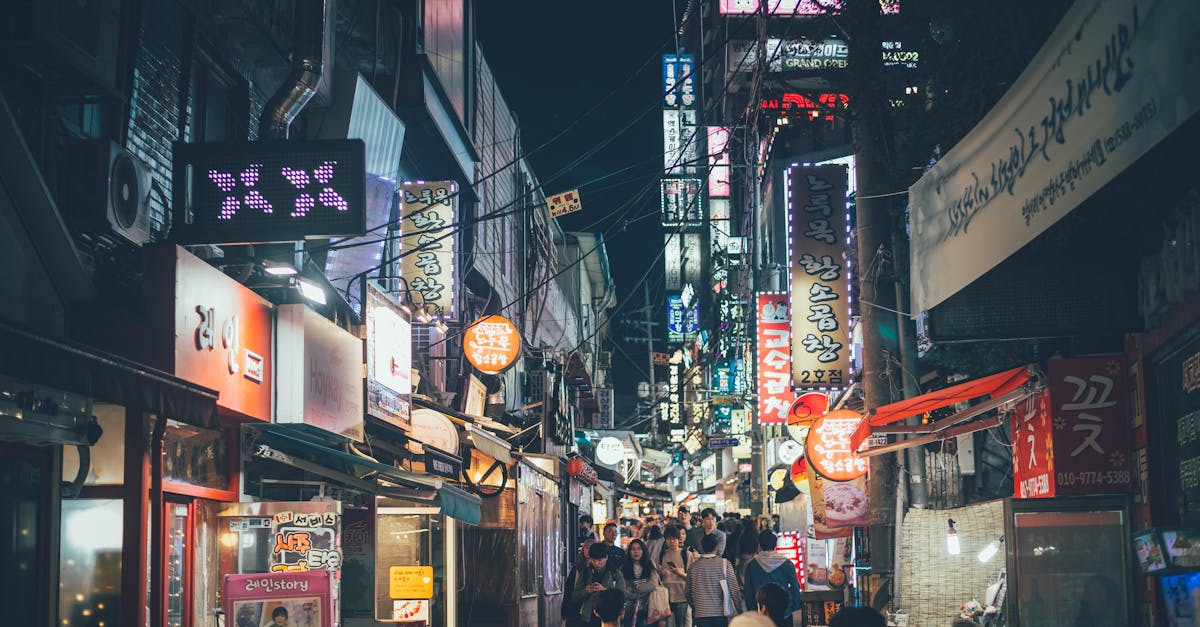 Bustling night market street in Seogyo-dong, Seoul with neon lights and crowds.