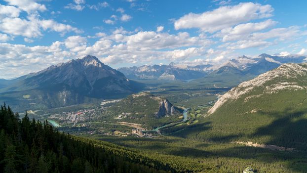A stunning aerial view of the majestic mountain range in Banff National Park under a clear blue sky.