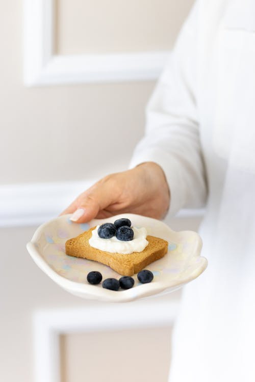 Female Hand Holding Plate with Meal