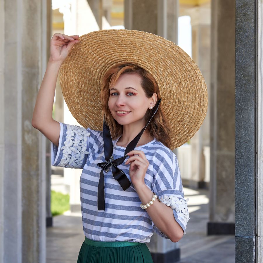 Smiling woman in a striped top and straw hat