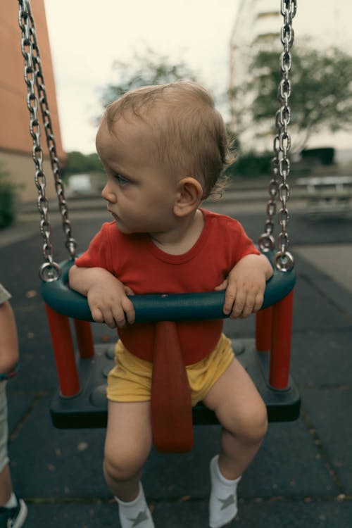 Baby Boy Sitting on a Swing