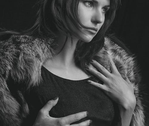 Grayscale Photo of a Woman in a Fur Jacket 