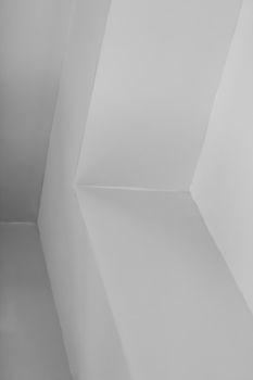 Abstract view of minimalist white walls creating geometric shapes indoors.
