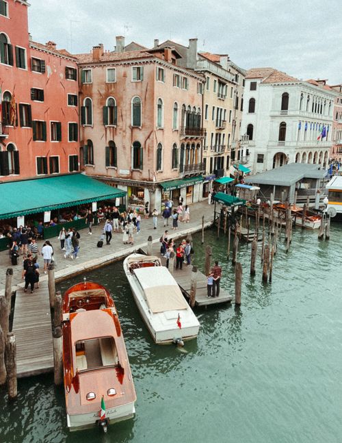 Free Captivating aerial view of Venice's canals, motorboats, and historic architecture, showcasing vibrant city life. Stock Photo