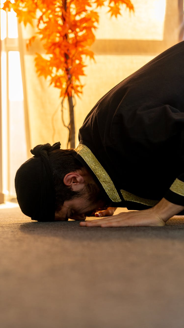 Man Praying With His Head Touching The Floor