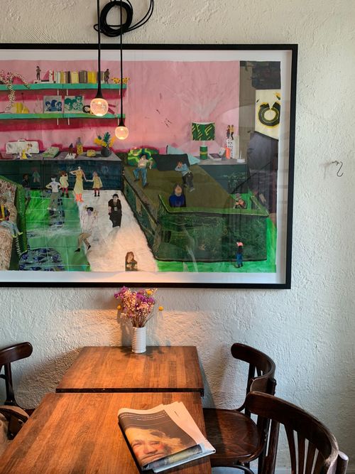 Free Explore a charming cafe in Kodaň, Dánsko with vibrant artwork and inviting wooden furniture. Stock Photo