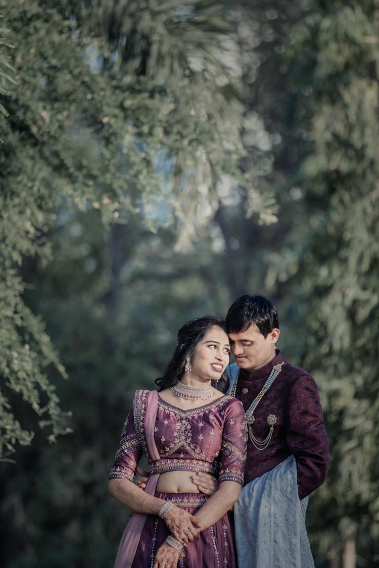 Bride And Groom In Traditional Clothes In Park