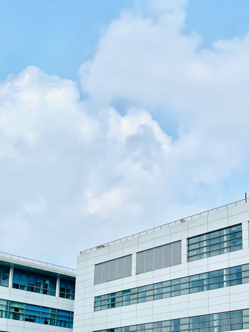 White Concrete Buildings Under White Clouds