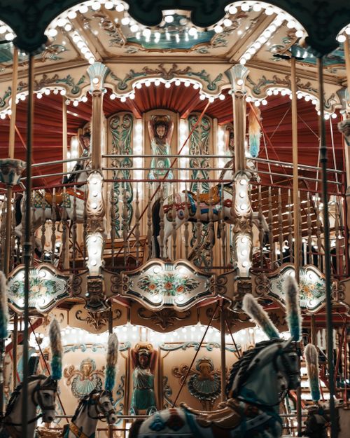 Free A beautifully lit vintage carousel with ornate designs at night, capturing a nostalgic feel. Stock Photo