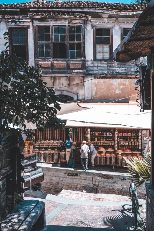 Free Bustling urban market scene with historic architecture and vibrant activity. Stock Photo