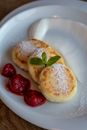 Appetizing Ukrainian curd fritters with strawberry jam for breakfast
