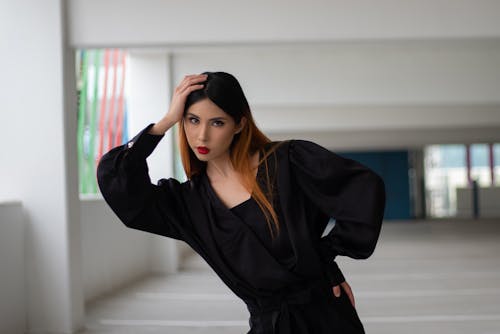 Woman in Black Long Sleeve Dress Posing 