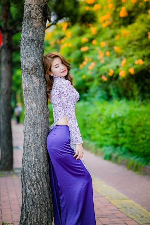 Woman Standing And Leaning On Tree 