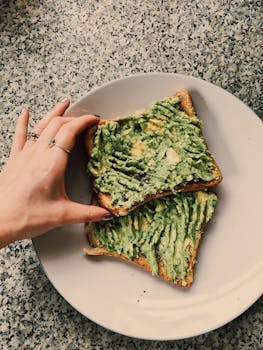 Delicious avocado toast on a ceramic plate, perfect for a healthy breakfast.