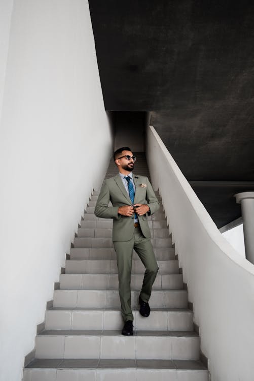 Man In Grey Suit Standing On Stair