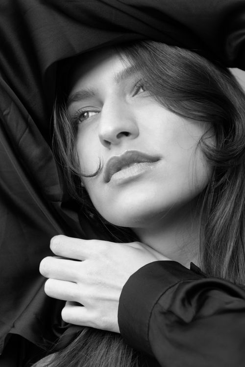 Free Striking black and white portrait showcasing elegance and emotion in a woman's gaze. Stock Photo