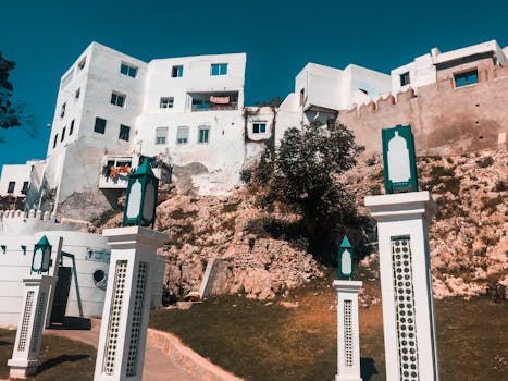 A scenic view of whitewashed buildings and decorative pillars against a clear sky.