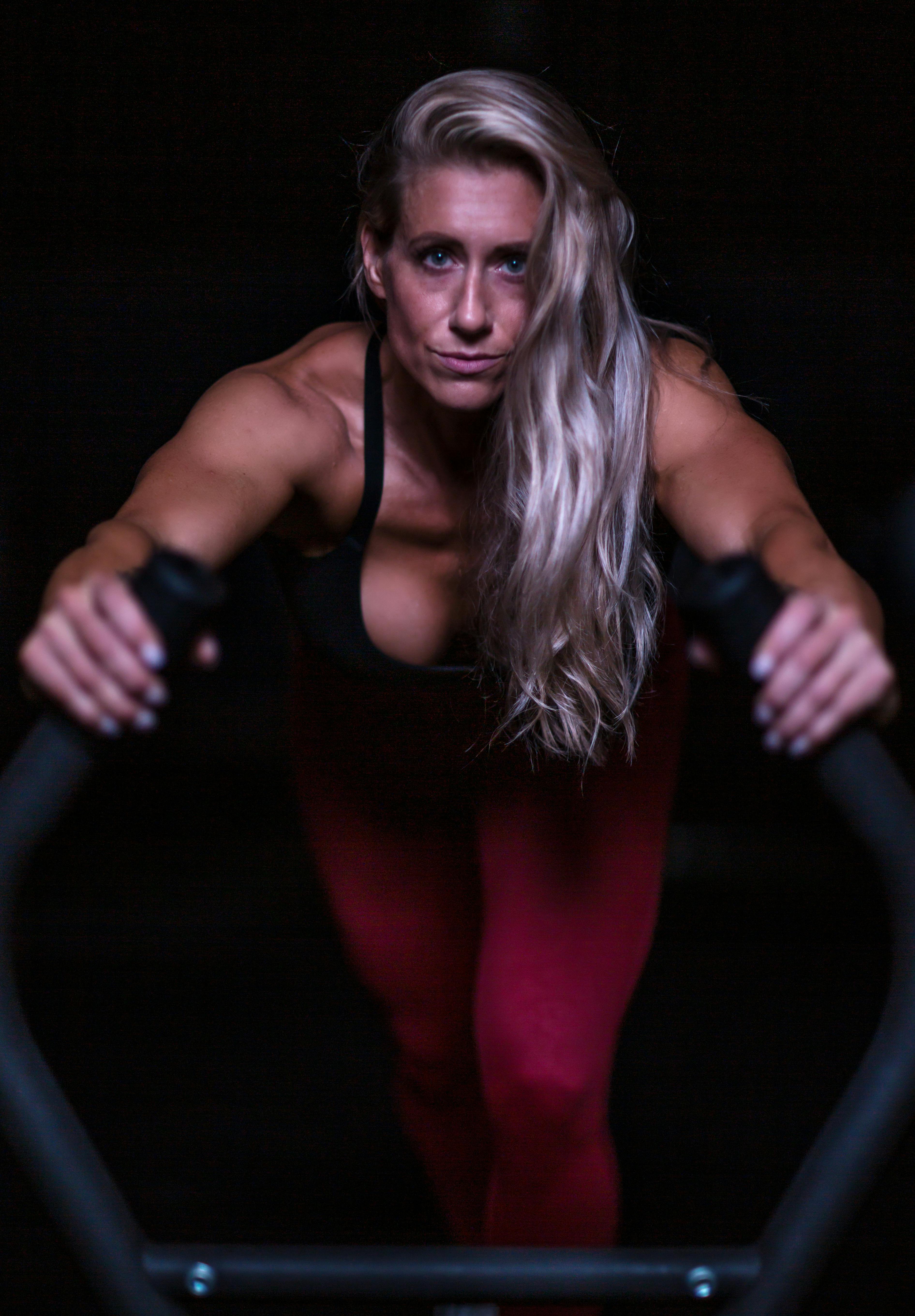 A Low Angle Shot of a Woman in Black Sports Bra Running on the Street ·  Free Stock Photo