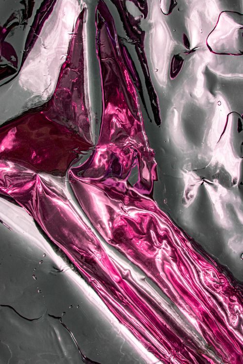 Free Close-up of a shiny abstract pattern with pink and silver hues, highlighting flowing textures. Stock Photo