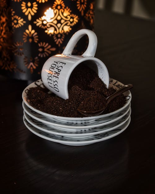 Ground Coffee in Cup and Saucer