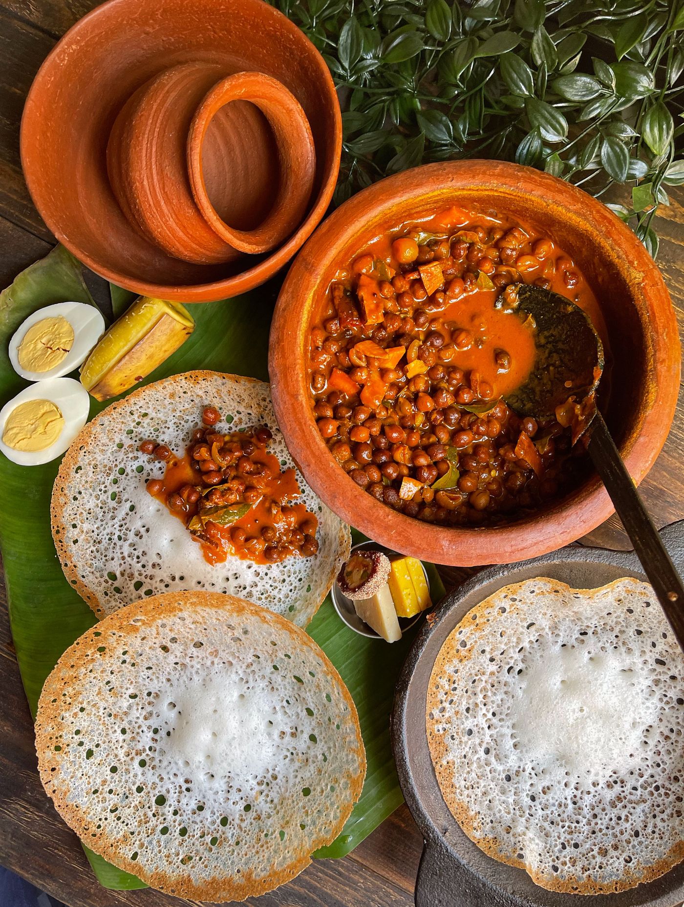 Appam with a bowl of stew