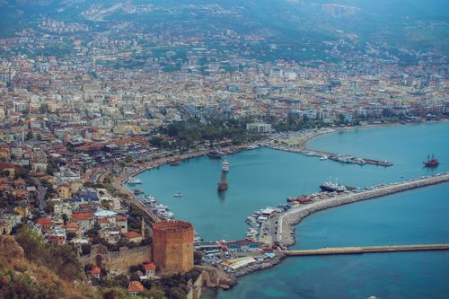Free Breathtaking aerial view of Alanya harbor with cityscape and Red Tower in Türkiye. Stock Photo