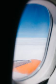 Stunning aerial view from an airplane window showing blue skies and wing.