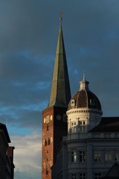 A gothic-style tower with a dramatic sky at dusk, showcasing architectural elegance.