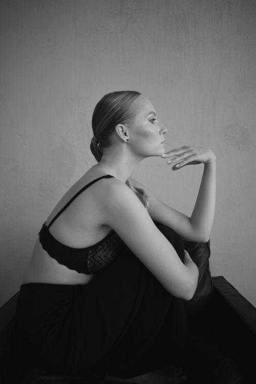 Free Artistic black and white portrait of a woman sitting thoughtfully in lingerie. Stock Photo
