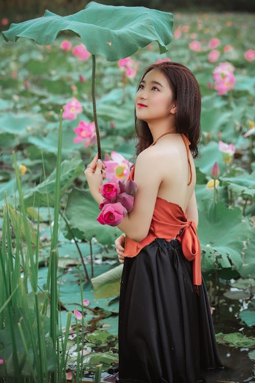 Woman Holding Big Leaf