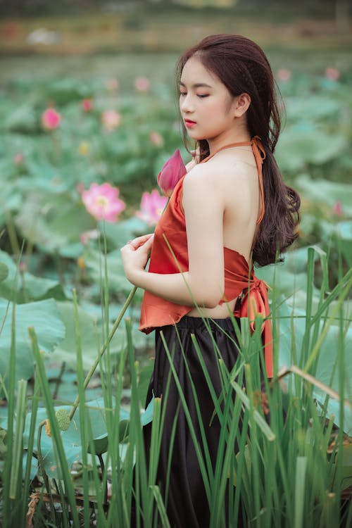 Free Woman Standing In The Middle Of Flowers Stock Photo