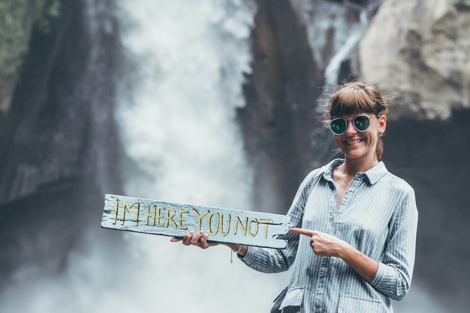 Woman Carrying Im Here You Not Plank on Front of Waterfalls