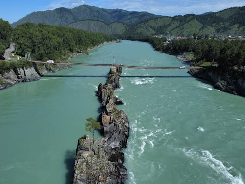 Cars Crossing a Bridge over a River