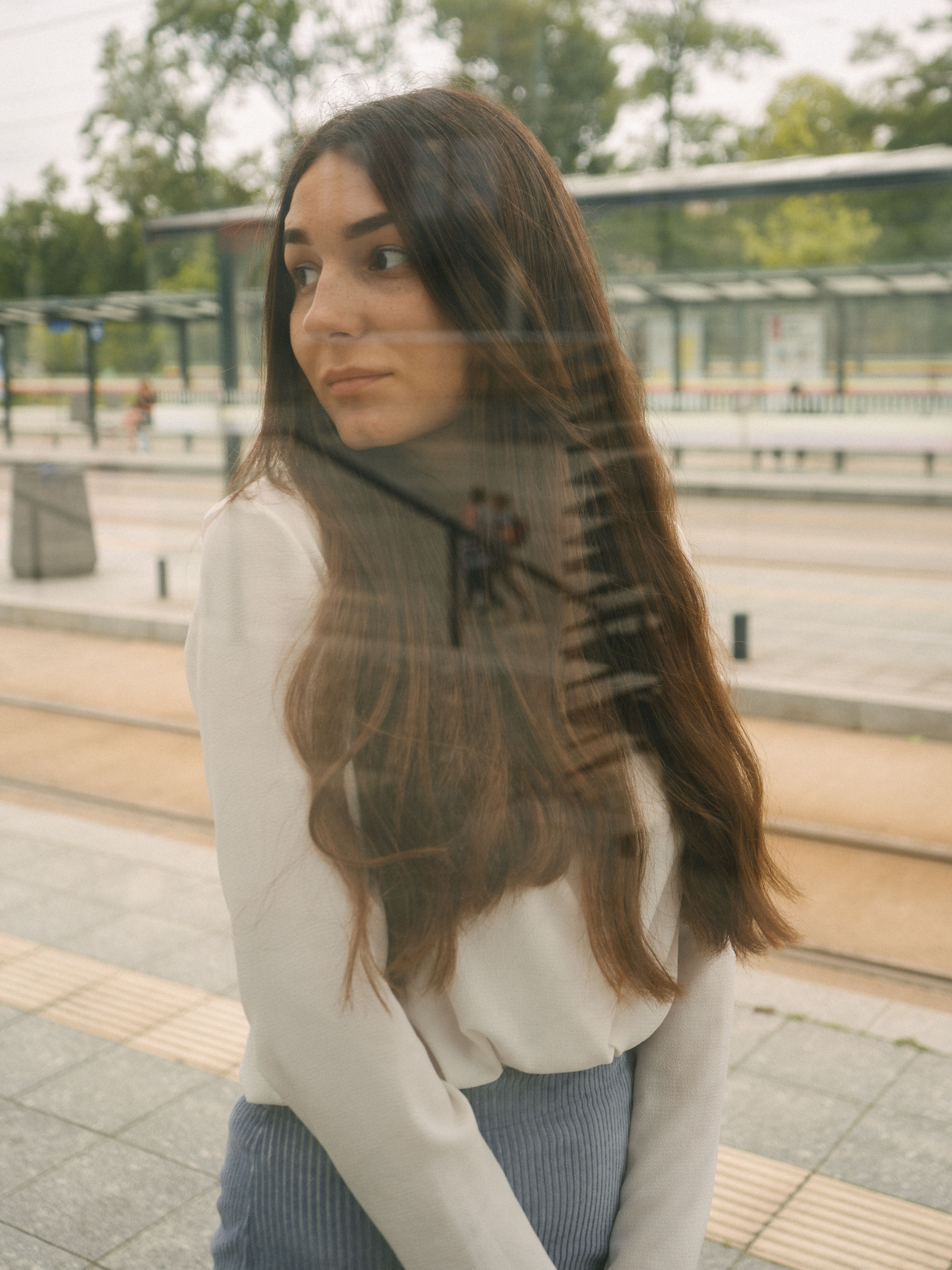 Woman in White Long Sleeves Standing Beside the Glass Wall · Free Stock ...