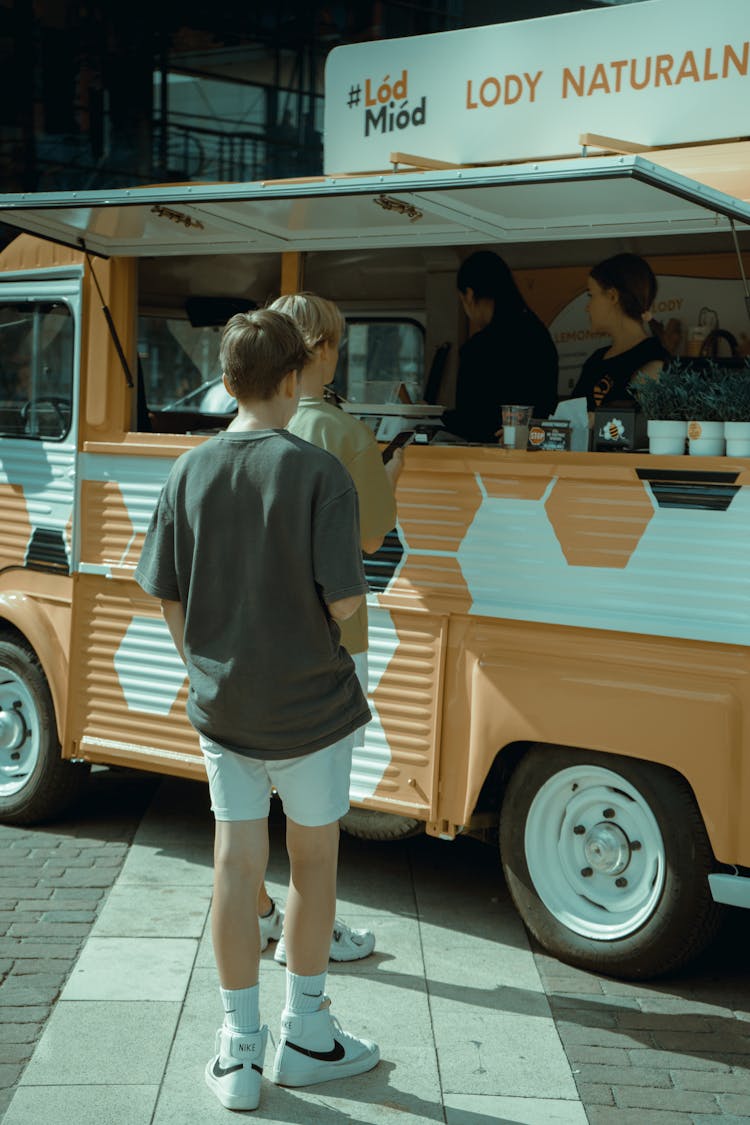 A Person Standing Near A Food Truck