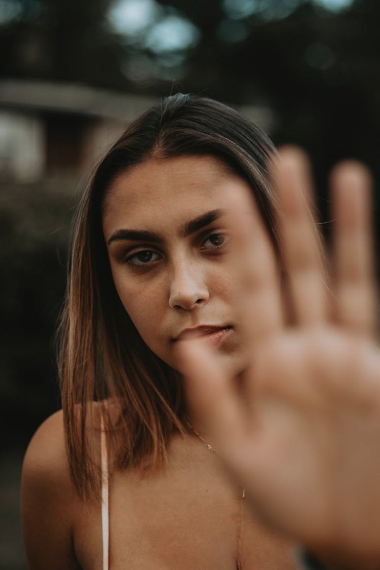 Portrait Of Woman Showing Palm To Camera