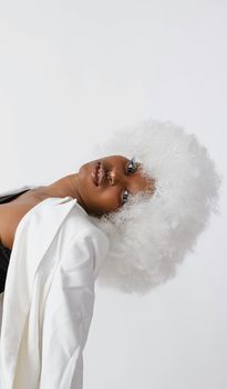 Portrait of an African American woman wearing a white wig, showcasing fashion and style.