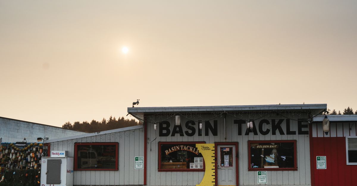 Sunlit facade of Basin Tackle shop, capturing rural charm in Bandon, Oregon.