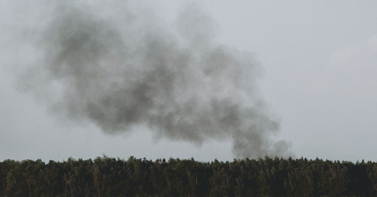 Fire Air Rising A Black Smoke Rising in the Air Near Body of Water · Free Stock Photo