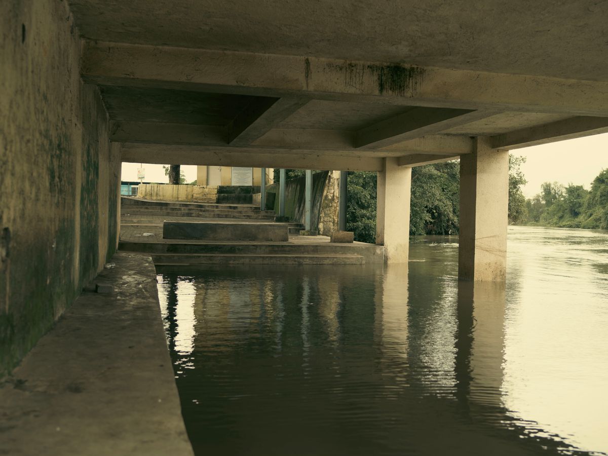 Flood water under a concrete structure.